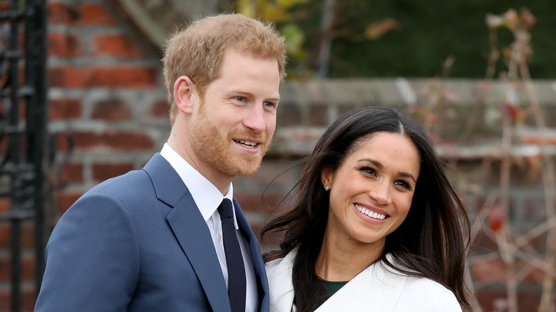 Prince Harry and Meghan Markle smiling