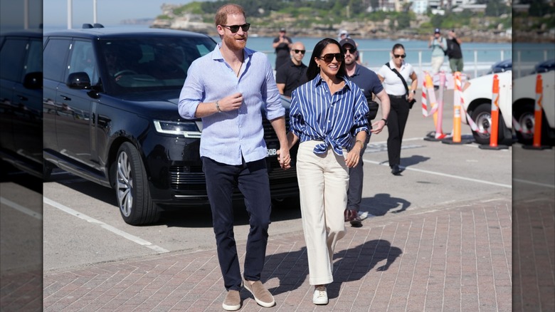 Prince Harry and Meghan Markle smiling during visit to Australia