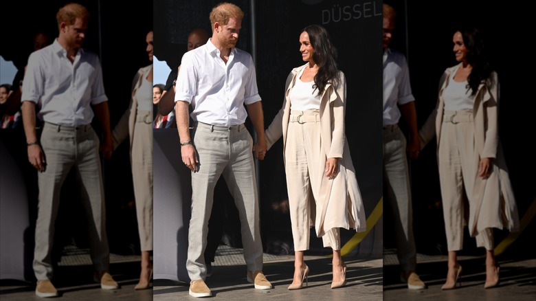 Prince Harry stands with Meghan Markle holding hands at Invictus Games