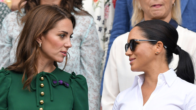 Kate Middleton looking at Meghan Markle