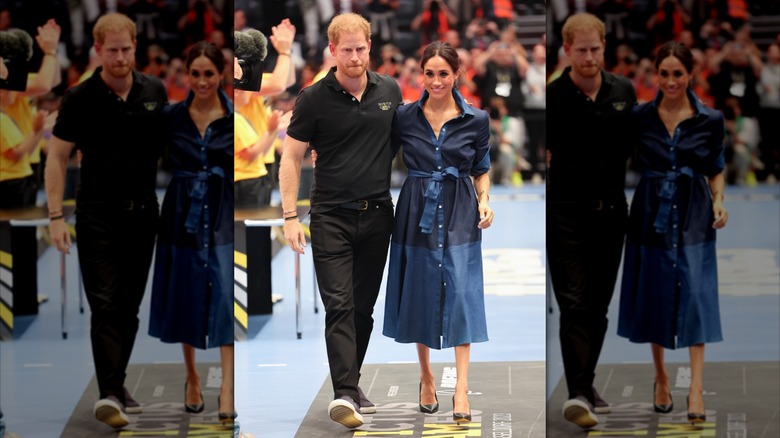 Prince Harry walking with his arm around Meghan Markle