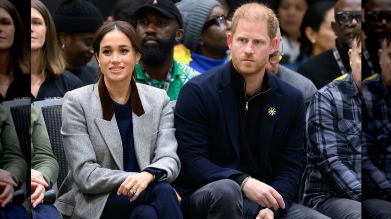 Meghan Markle and Prince Harry siting together courtside