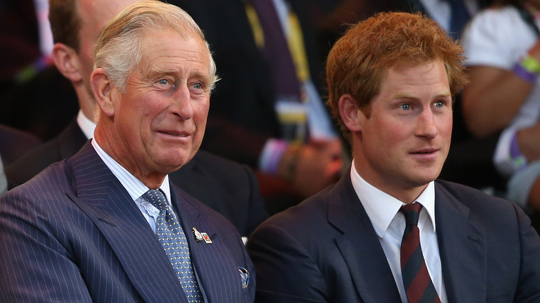 King Charles and Prince Harry sit side by side