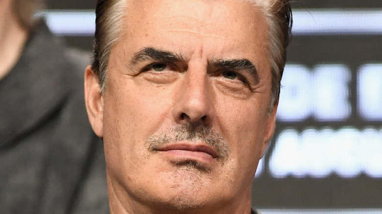 Chris Noth looking up grumpily at an event