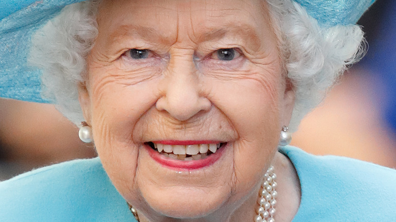 Queen Elizabeth blue hat smiling
