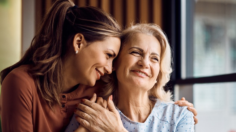 two women smiling and hugging