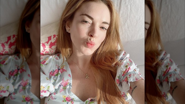 Lindsay Lohan wearing a floral top and puckering her lips