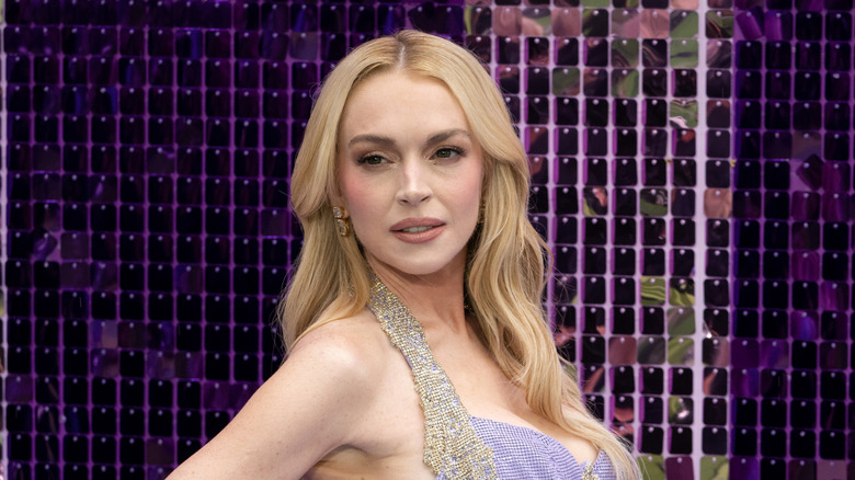 Lindsay Lohan wearing a purple dress and smizing