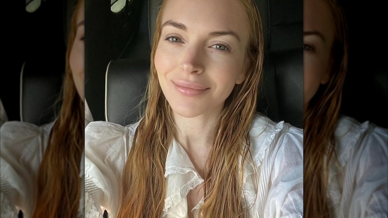Selfie of Lindsay Lohan with wet hair in a white top