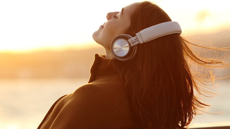 Relaxed woman wearing headphones with her head tilted back