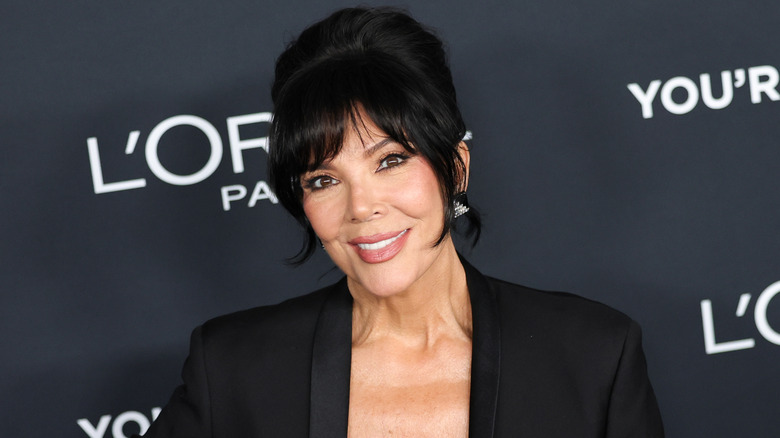 Kris Jenner smiling while posing on the red carpet