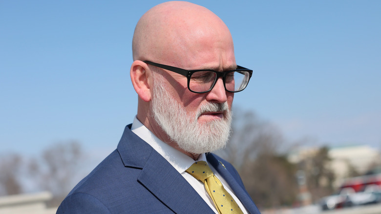 Rep. Derrick van Orden wearing glasses and a suit