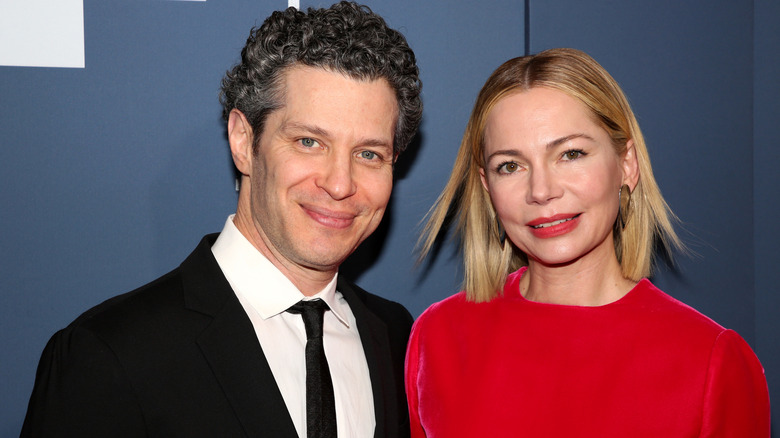 Thomas Kail and Michelle Williams smiling at the Booth Theatre in 2026