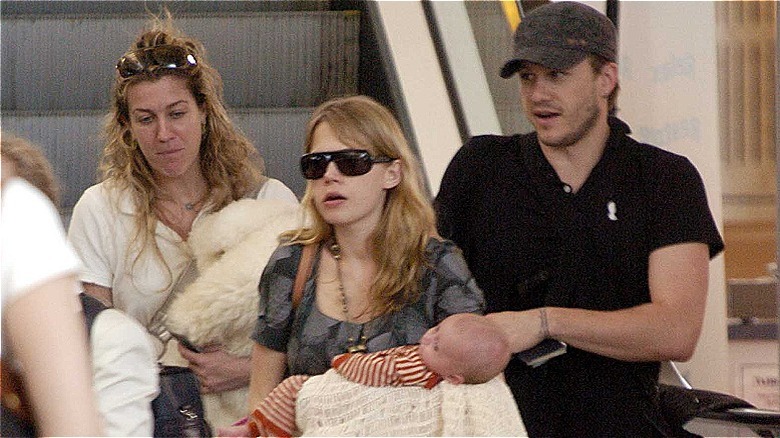 Michelle Williams and Heath Ledger with baby Matilda at the Sydney Airport