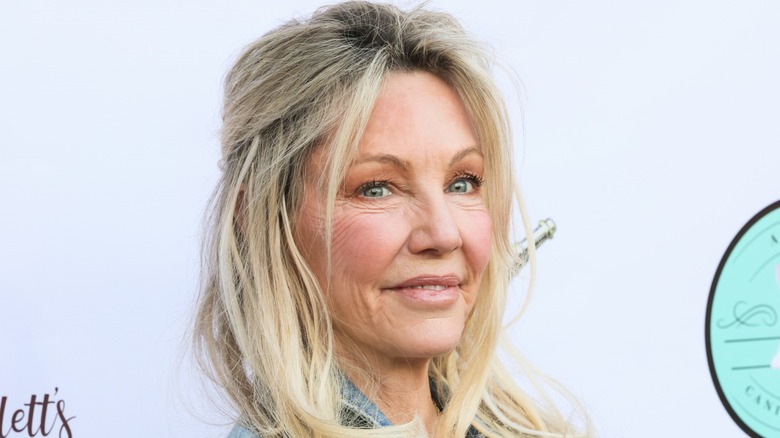 Heather Locklear wearing a denim jacket looking at the camera