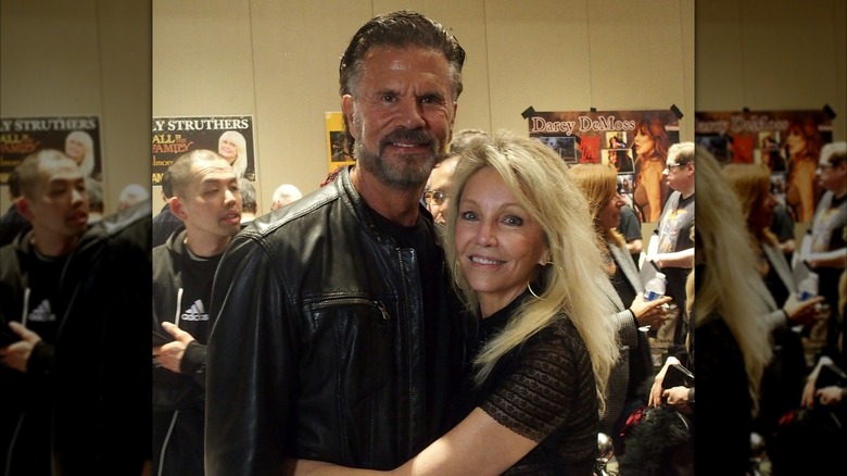 Lorenzo Lamas and Heather Locklear posing and hugging.