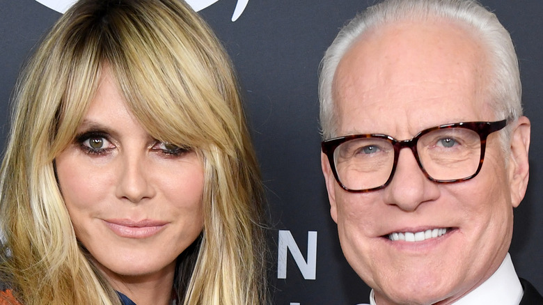 Heidi Klum and Tim Gunn smiling on the red carpet