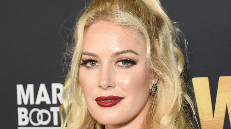 Heidi Montag with ponytail and bold red lipstick at event
