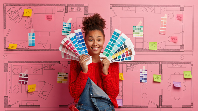 girl holding up color swatches trying to decide what to paint where