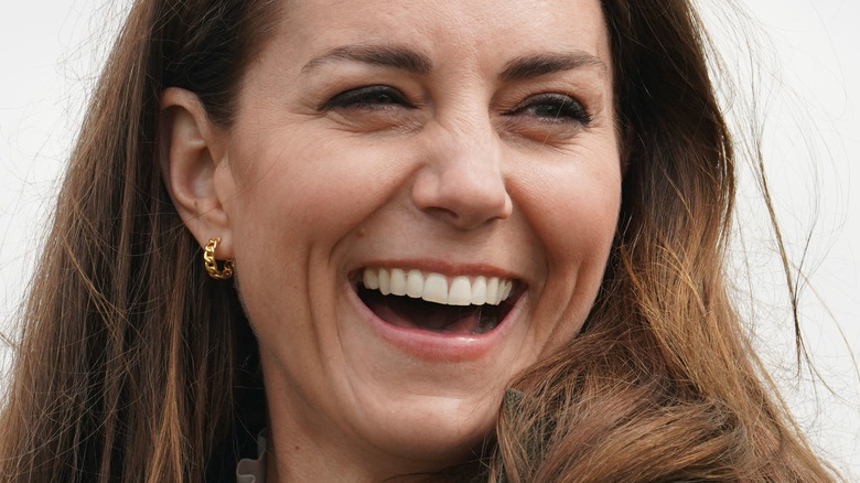 Kate Middleton laughing, cloudy day