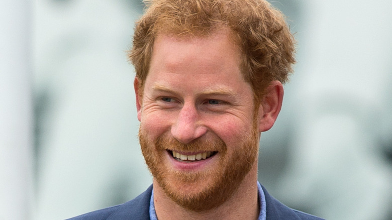 Prince Harry wears a dark blue suit