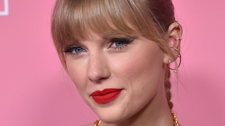Taylor Swift grinning red lipstick and braid