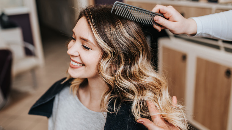 Woman with balayage hair smiles