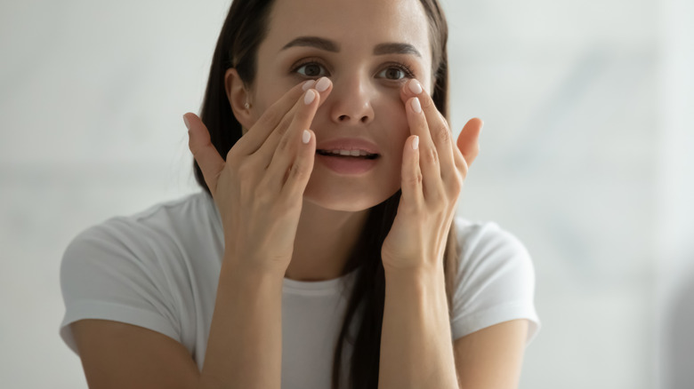 Women putting on foundation