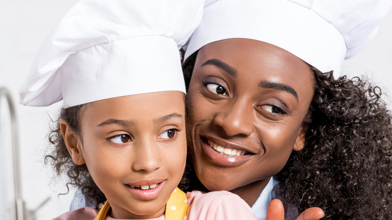 Mother and daughter cooking together