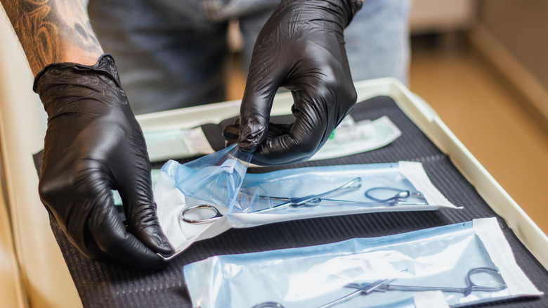 Man opening piercing instruments