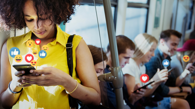 people on subway looking at phones