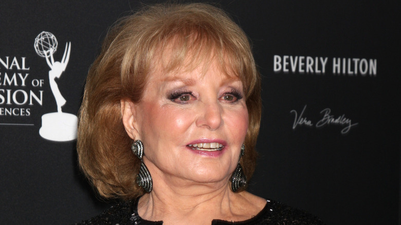 Barbara Walters smiling in a black dress at the primetime emmy awards.