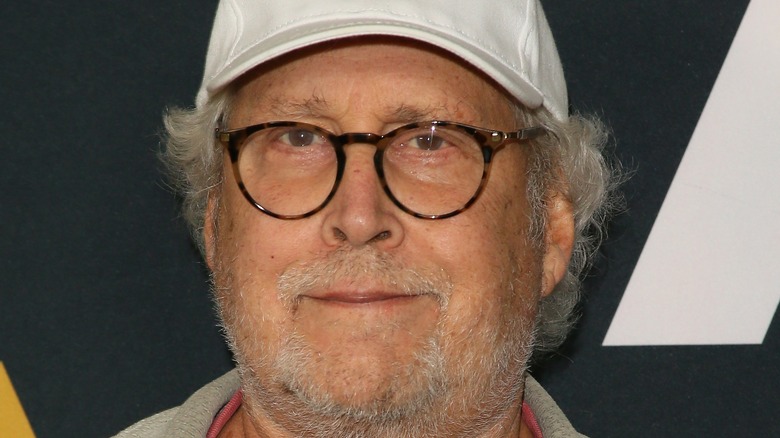 Chevy Chase in glasses and a ball cap