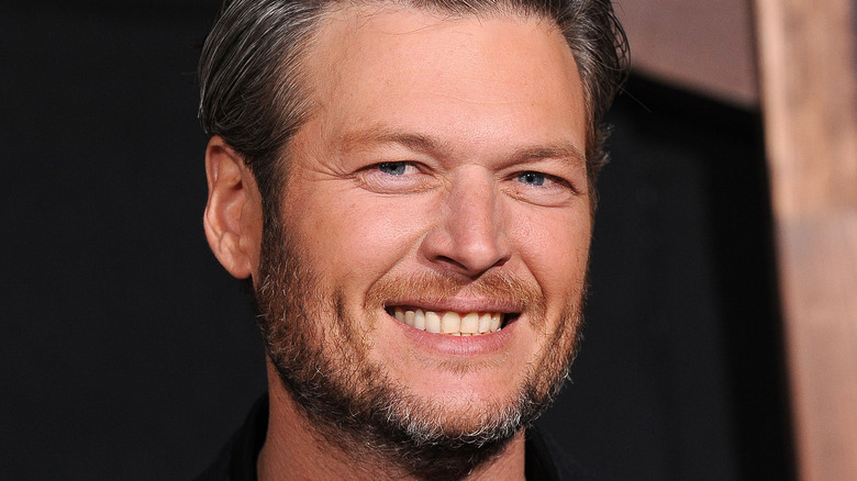 Blake Shelton smiles at an event.