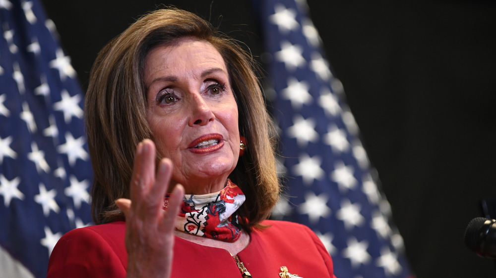 Nancy Pelosi in front of US flag