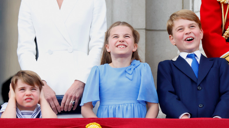 Louis, Charlotte, and George on balcony