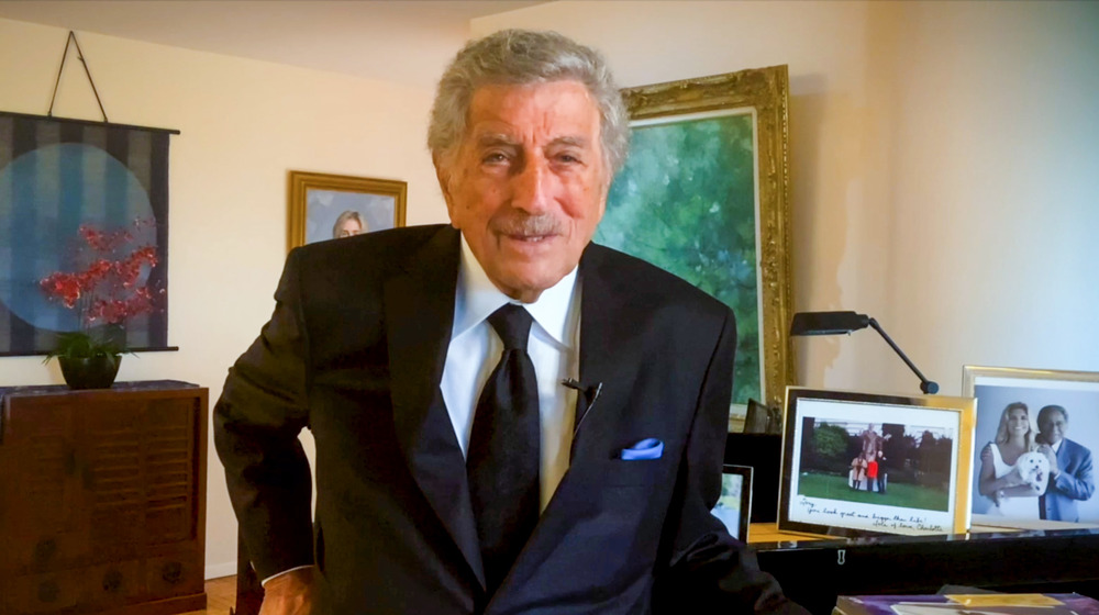 Tony Bennett standing by his piano