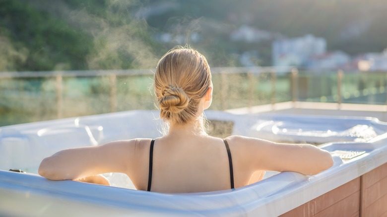 Woman sits in hot tub
