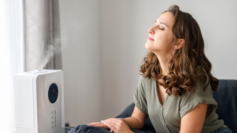 Woman breathing in a humidfier.