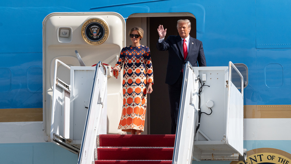 Donald and Melania Trump waving outside Air Force One