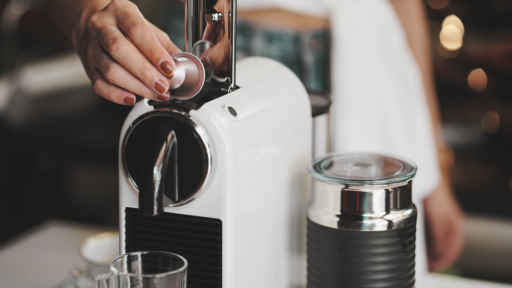 Person using coffee maker