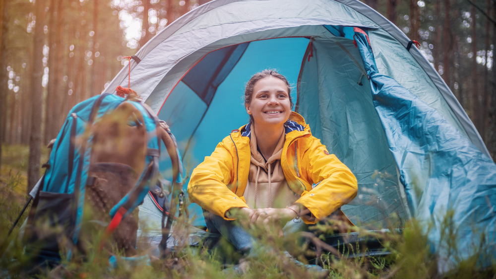 Woman camping in tent