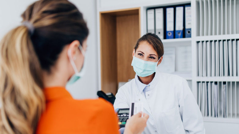 A woman picking up her prescription