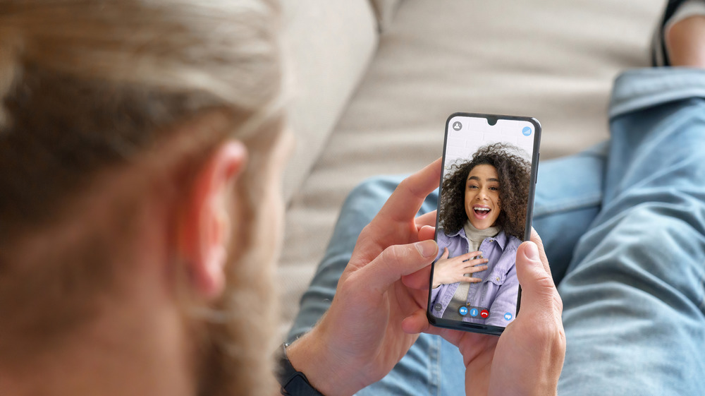 Young man and woman talking through video chat