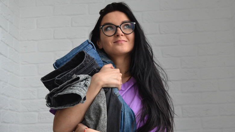 Woman holding her favorite jeans 