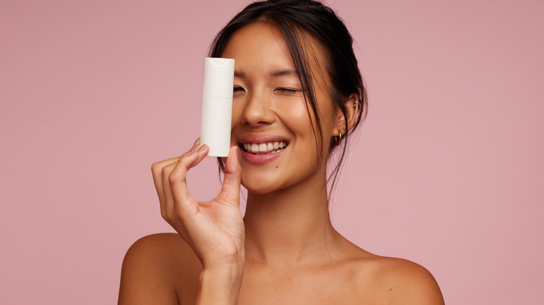 Woman holding a skincare product