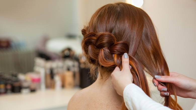 Woman having her hair braided