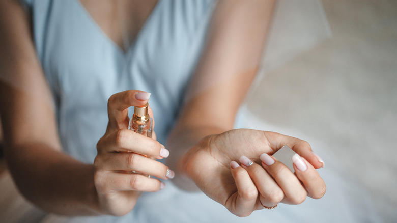 Woman applying perfume