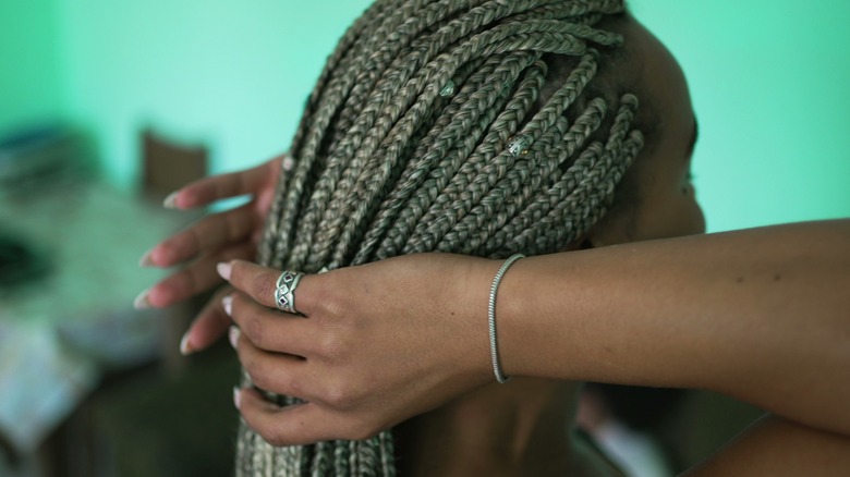 Woman holding her braids