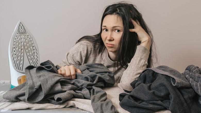 Woman upset at ironing board